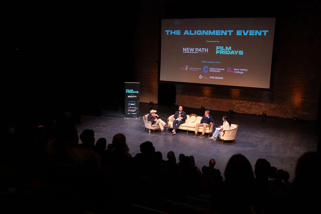 Panel and audience beneath The Alignment Event screen.